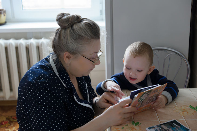 A quizzical boy asking lots of questions to his carer.