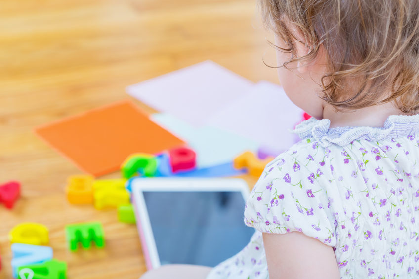 45663146 - toddler girl watching a tablet computer