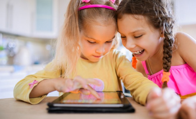 2 girls using digital technologies in the nursery