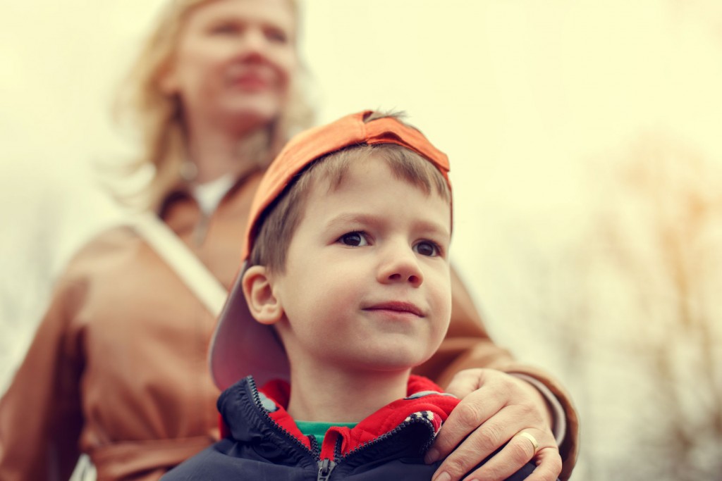 Foster parent – mother with little boy in vintage style, outdoor portrait