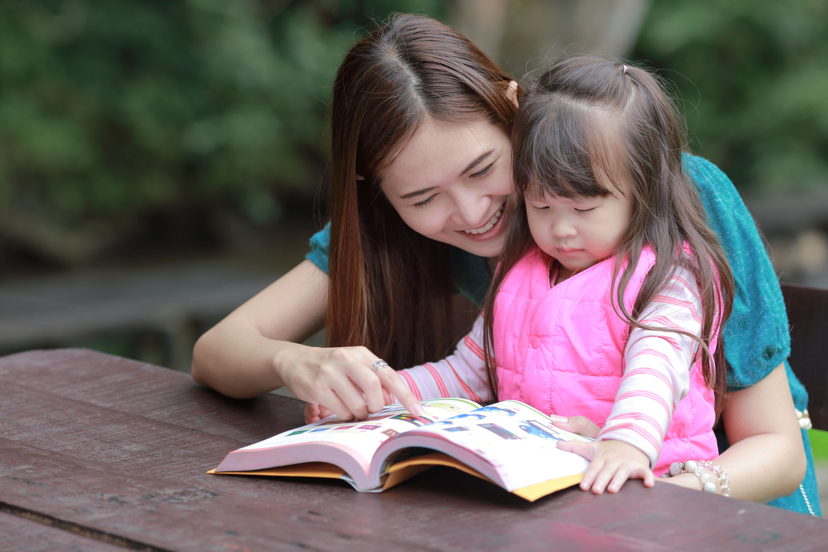 foster parent - lady teaching child to read