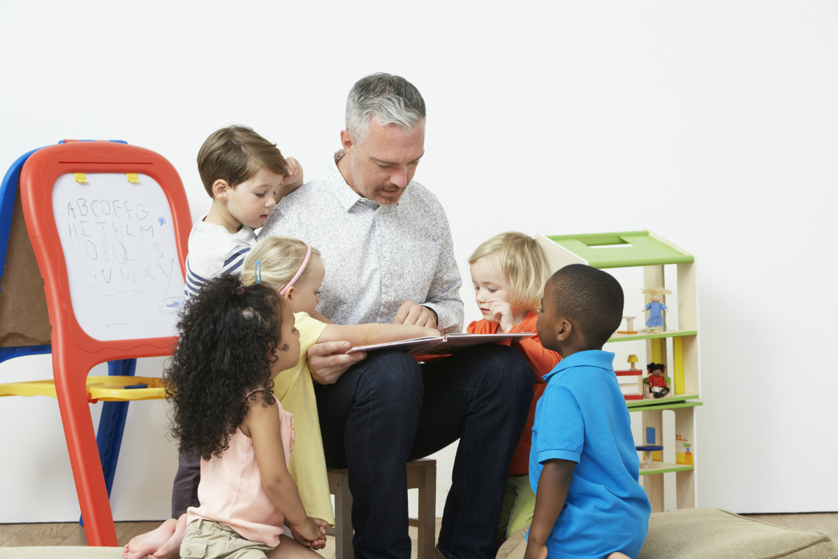 Early years literacy games - teacher reading a story