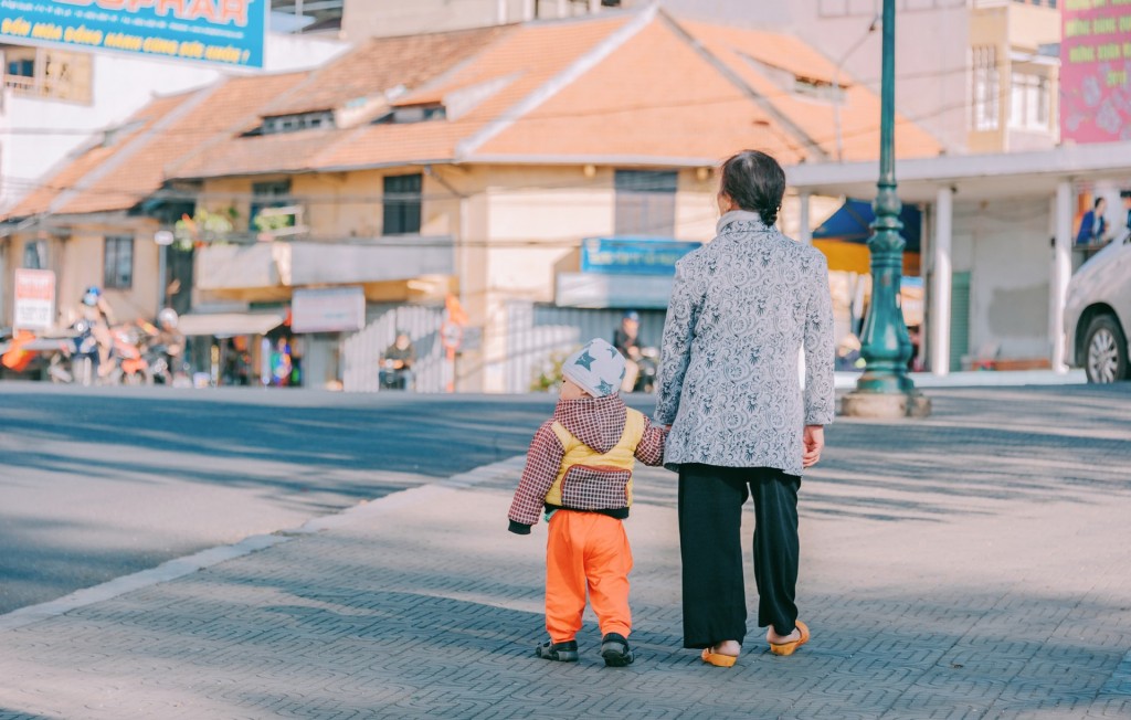 woman-and-boy-walking-at-road-1351751